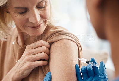 Buy stock photo Shot of a doctor giving a senior woman an injection at home