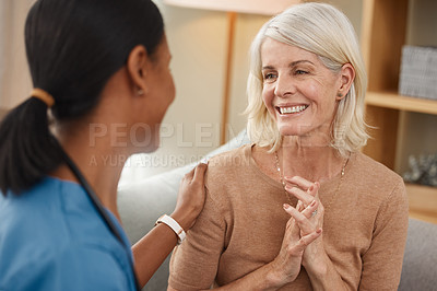 Buy stock photo Shot of a doctor having a consultation with a senior woman at home