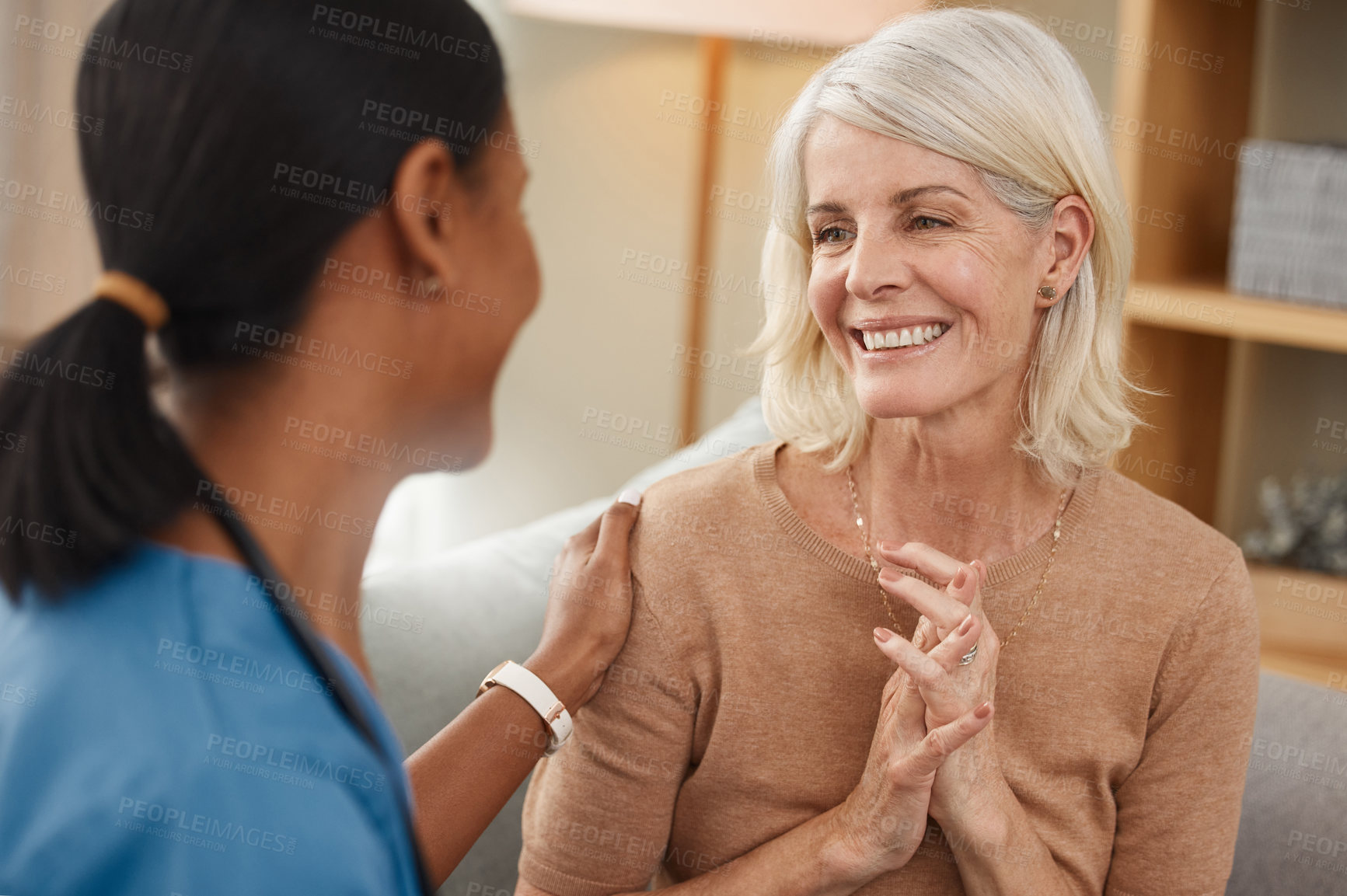 Buy stock photo Shot of a doctor having a consultation with a senior woman at home