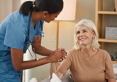 Buy stock photo Shot of a doctor having a consultation with a senior woman at home