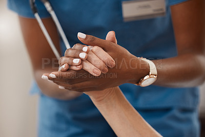 Buy stock photo Shot of a doctor holding hands with her patient during a consultation at home