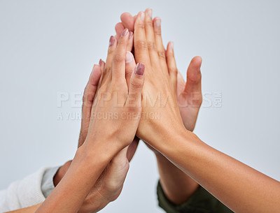 Buy stock photo Closeup shot of a group of people giving each other a high five against a white background