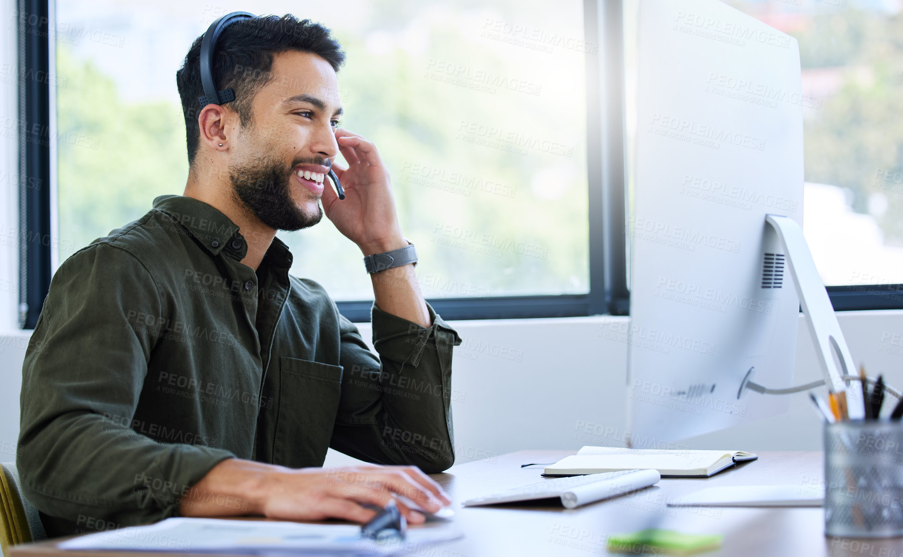 Buy stock photo Shot of a young male call center worker