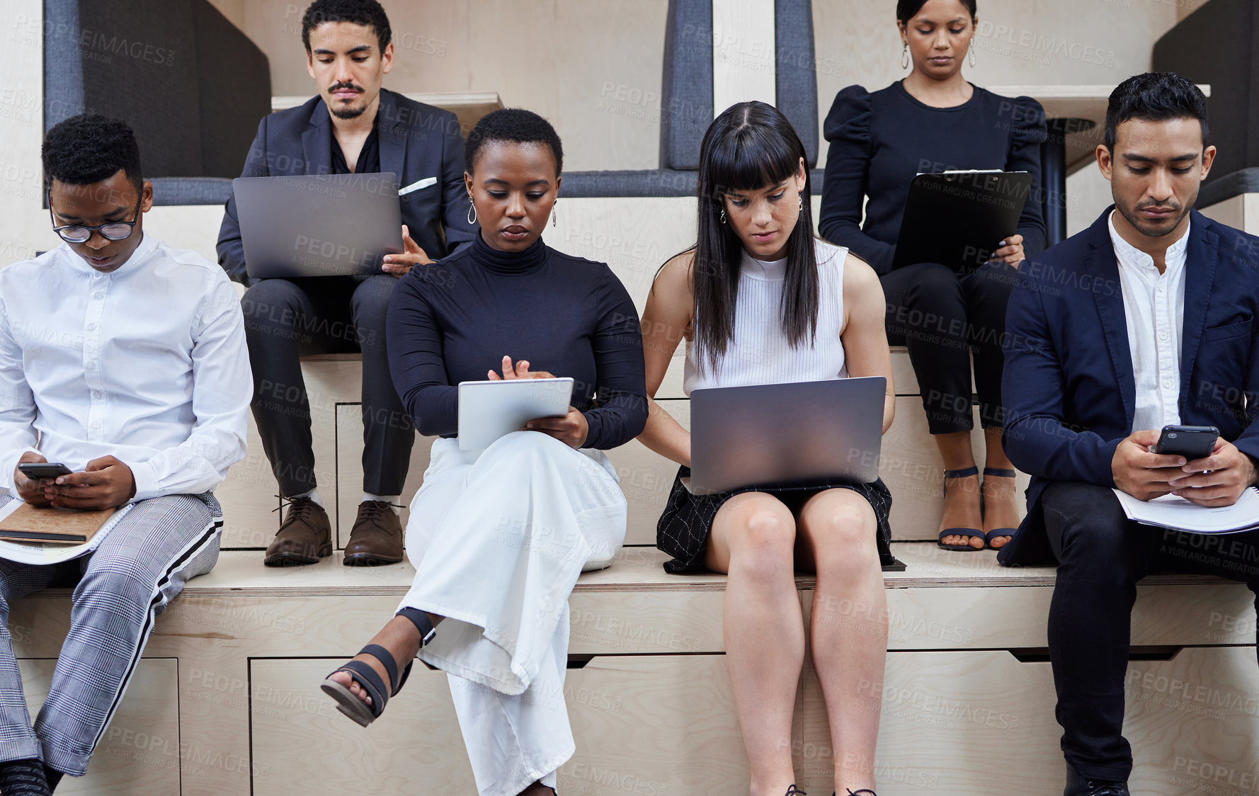 Buy stock photo Shot of a group of businesspeople working together in a cafe