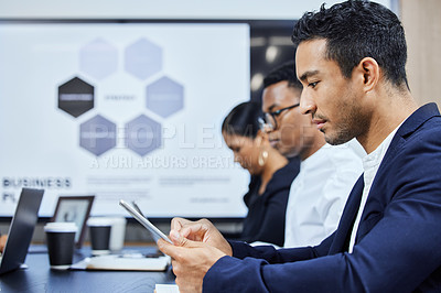 Buy stock photo Shot of a young businessman using a digital tablet during a meeting in an office
