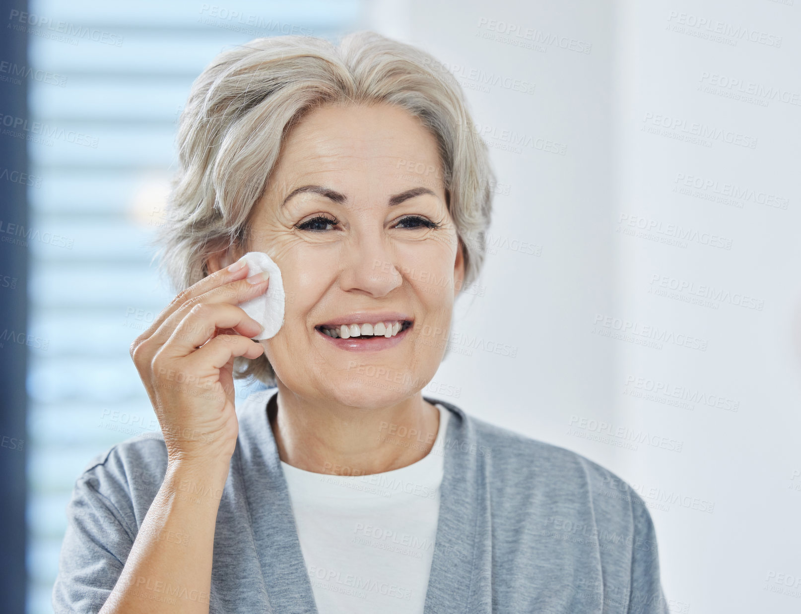 Buy stock photo Home, bathroom and senior woman with skincare for wellness, facial health and makeup removal. House, elderly person and cotton pad for lotion, cream and moisturizer application in retirement