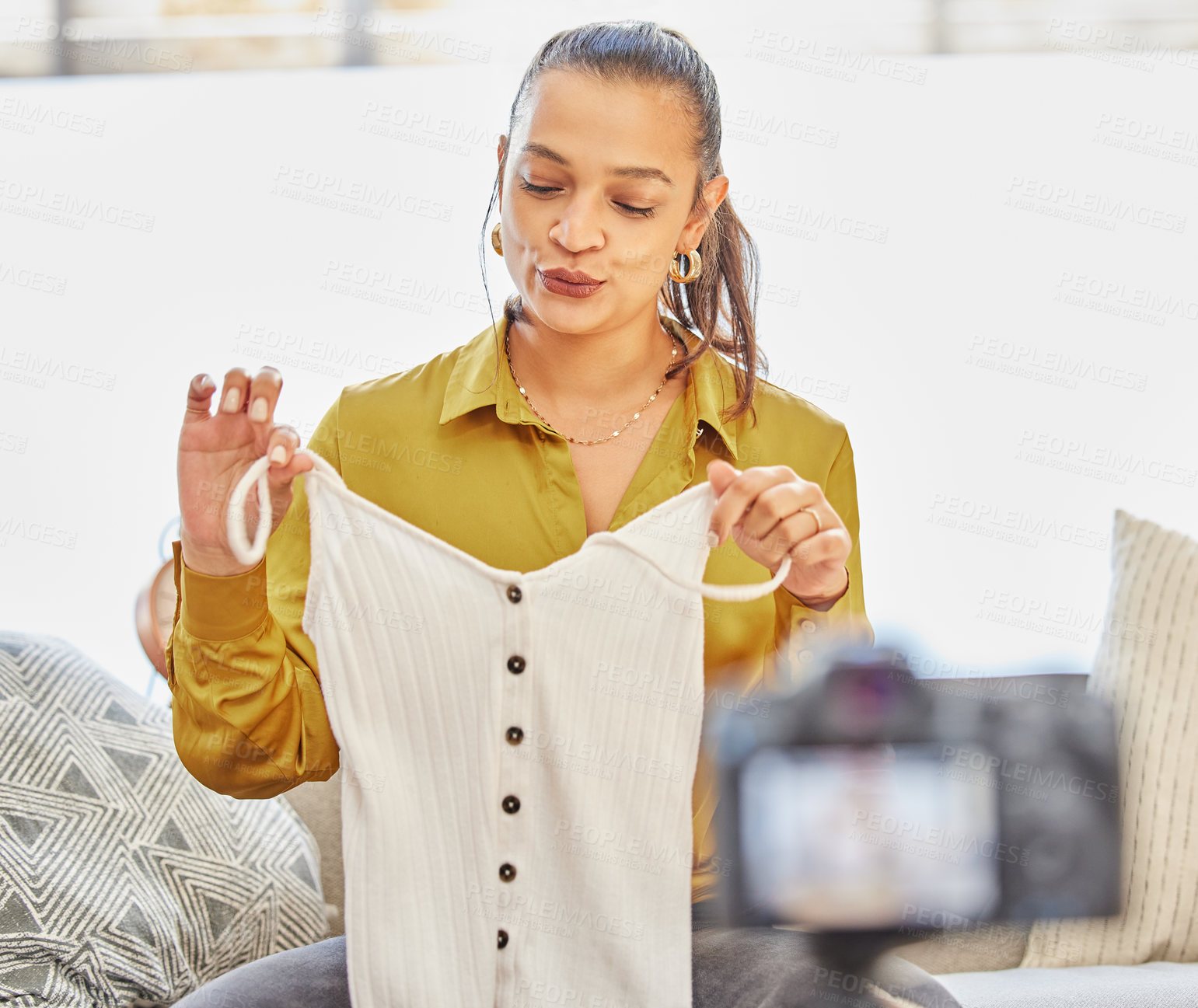 Buy stock photo Shot of a young woman recording a video for her vlog at home