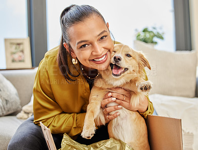 Buy stock photo Shot of a young woman sitting at home with an adorable little dog