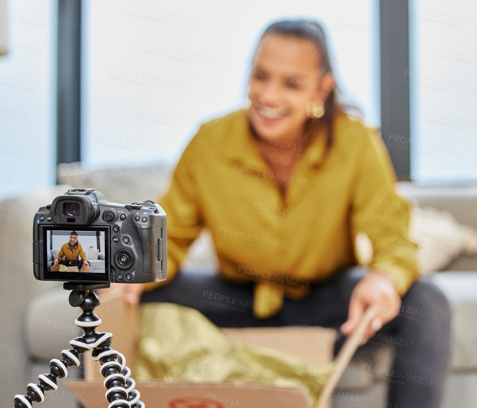 Buy stock photo Shot of a young woman recording a video for her vlog at home