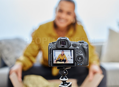 Buy stock photo Shot of a young woman recording a video for her vlog at home