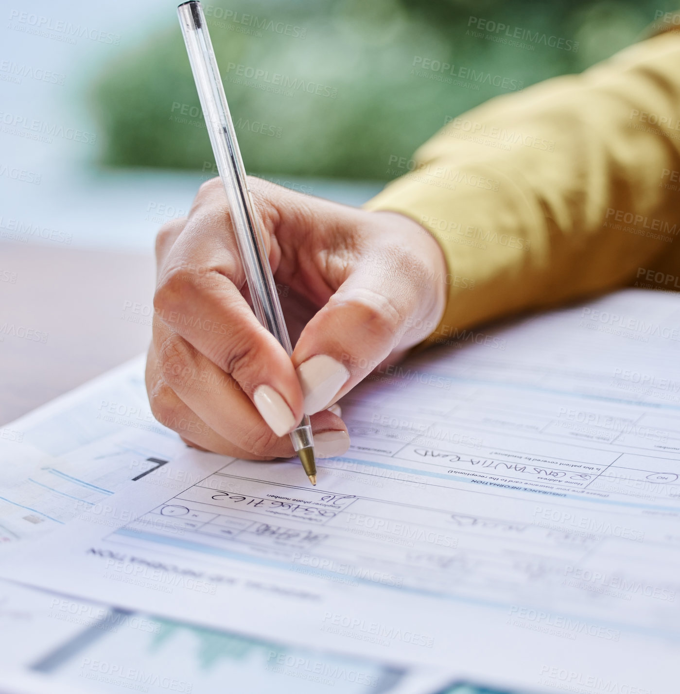 Buy stock photo Cropped shot of an unrecognizable businesswoman filling out paperwork while working from home