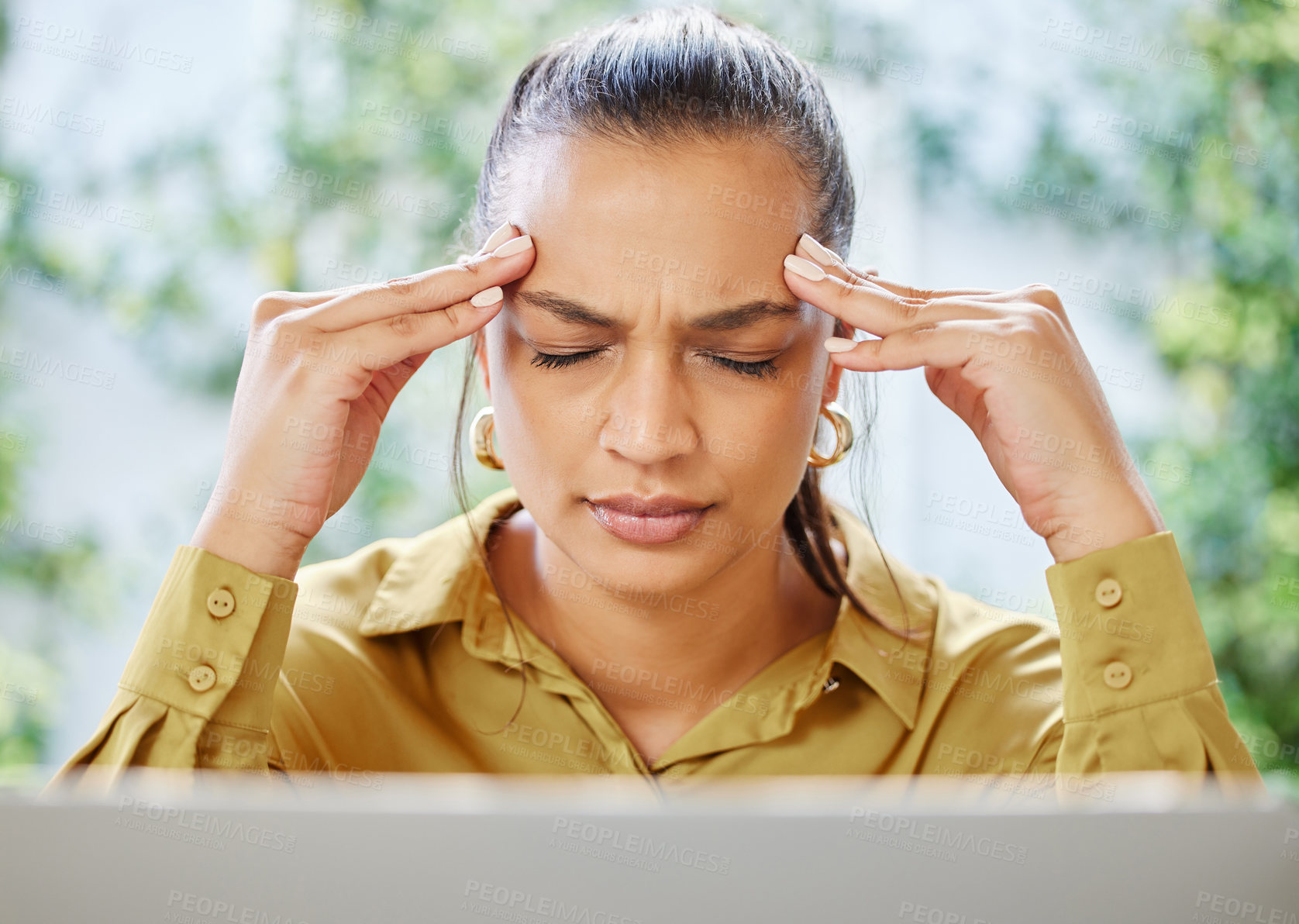 Buy stock photo Cropped shot of an attractive young businesswoman looking stressed while working on her laptop at home