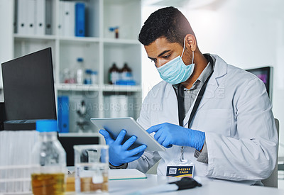 Buy stock photo Scientist man, tablet and typing in lab for medical, pharmaceutical or covid research in face mask. Young male doctor, innovation and website for test, check and science app for virus in laboratory