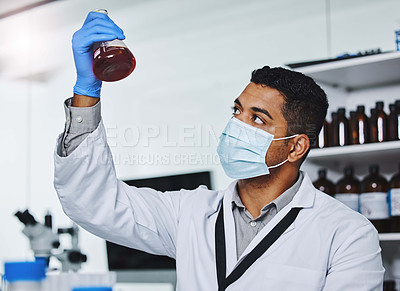 Buy stock photo Shot of a young male researcher working in a laboratory
