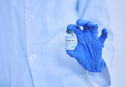 Buy stock photo Cropped shot of an unrecognizable scientist holding up a bottle of the covid 19 vaccine