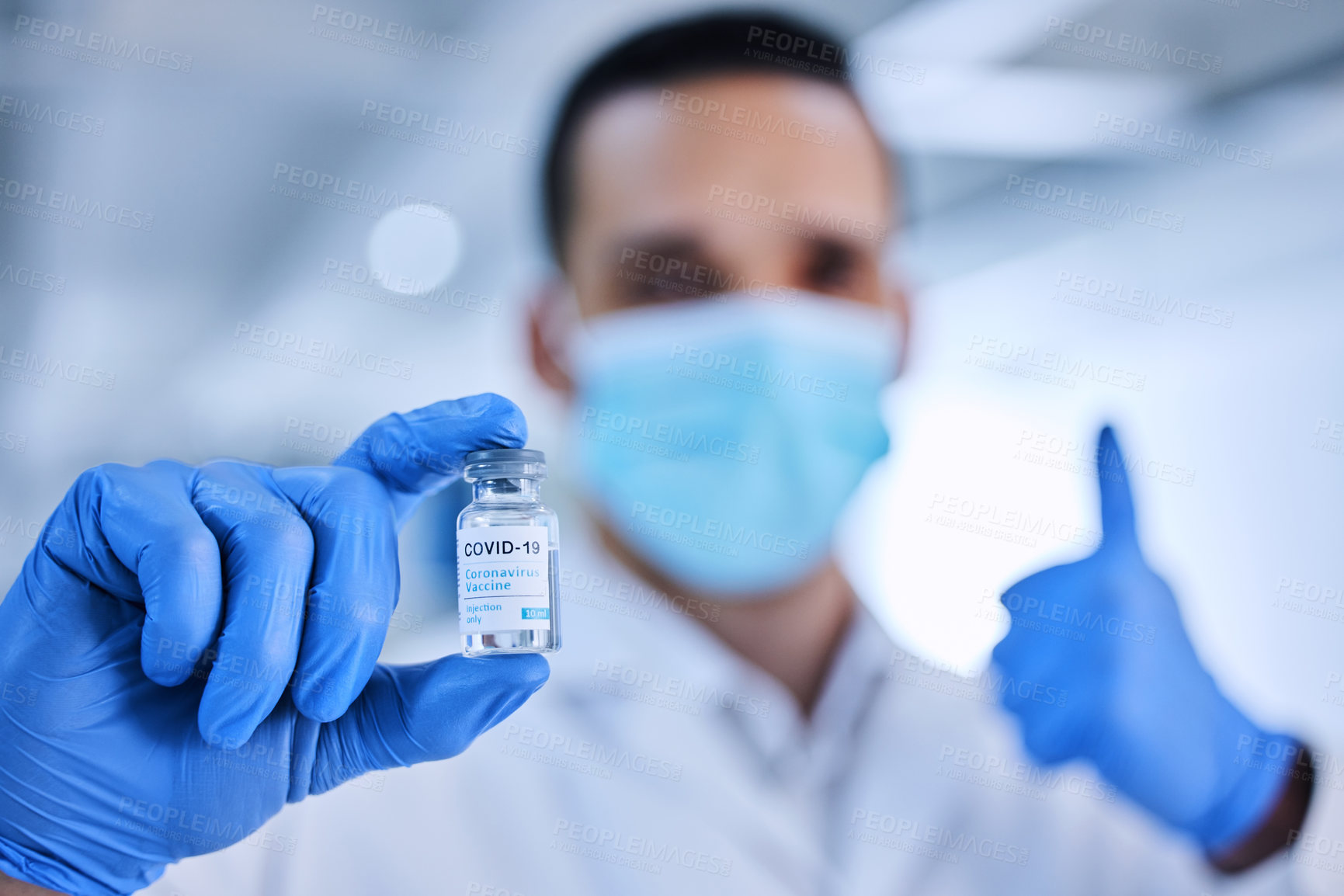 Buy stock photo Cropped shot of an unrecognizable male scientist holding up a bottle of the covid 19 vaccine