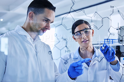 Buy stock photo Cropped shot of two young scientists working on a glass wipe board in their lab
