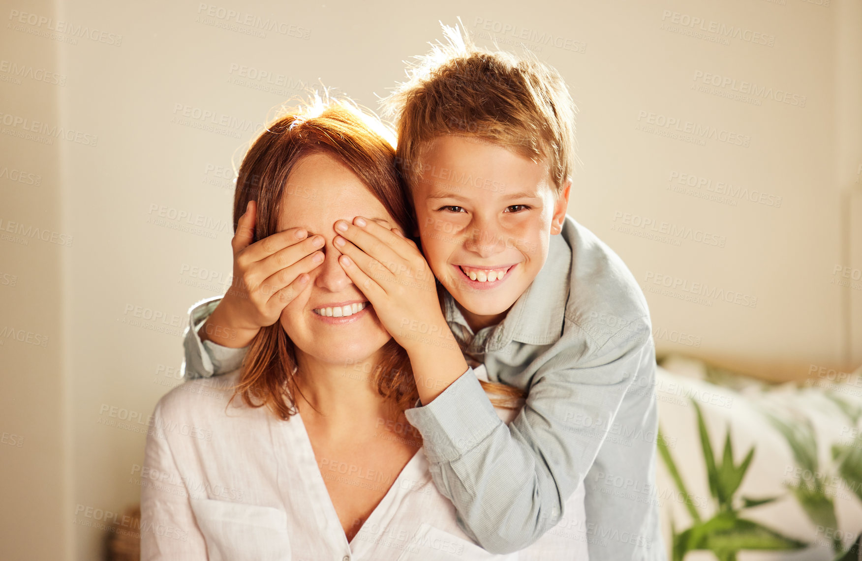 Buy stock photo Boy, mom and cover eyes for surprise with smile in portrait for bonding, care and connection in home. Mother, child and happy for games, playful and relax together in lounge with love at family house