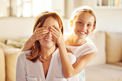 Buy stock photo Shot of an adorable little girl bonding with her mother at home and covering her eyes to surprise her