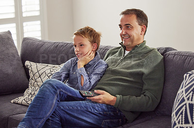 Buy stock photo Happy, man and child together watching tv on sofa, couch and relax at home in living room. Television, movie and people in house or apartment for streaming comedy, video and broadcast in lounge