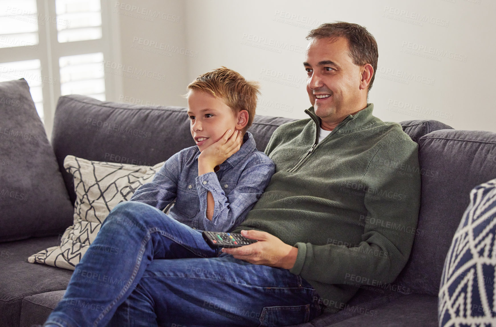 Buy stock photo Happy, man and child together watching tv on sofa, couch and relax at home in living room. Television, movie and people in house or apartment for streaming comedy, video and broadcast in lounge