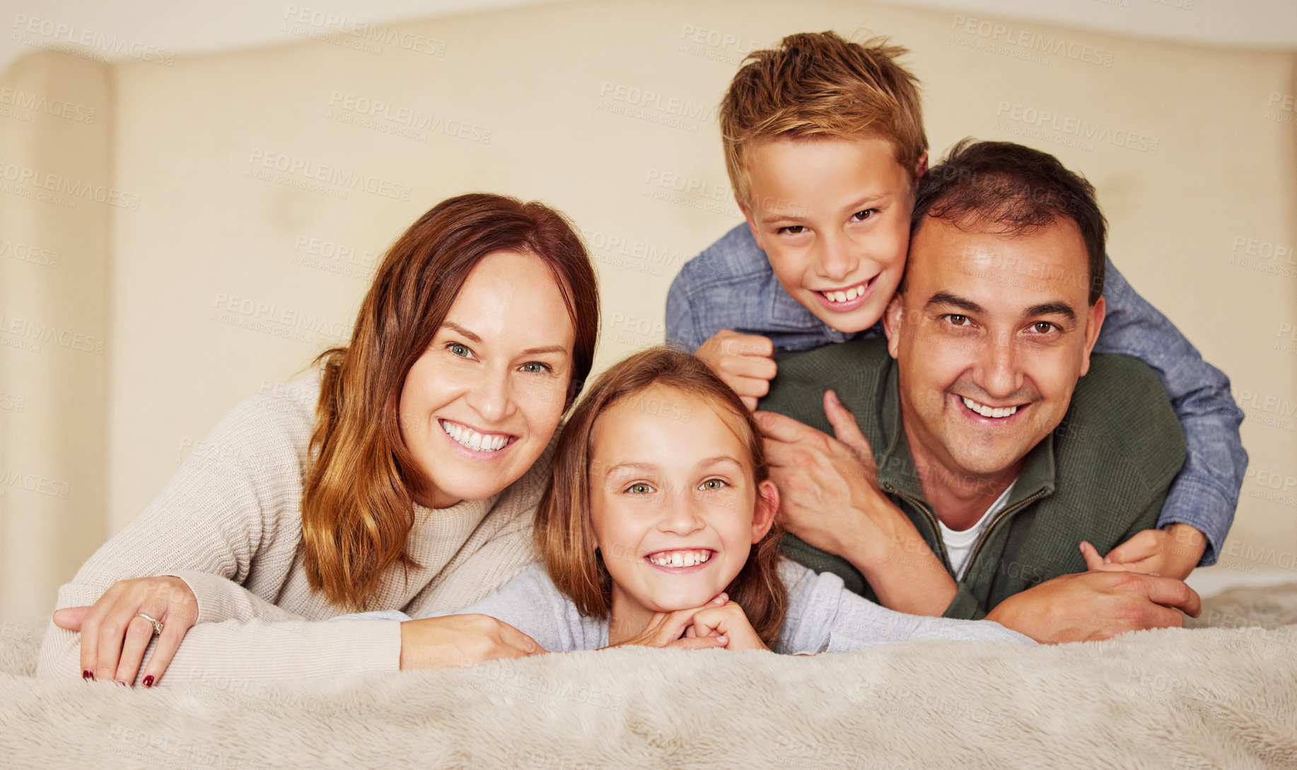 Buy stock photo Happy family, parents and children with face on bed for bonding, peace or love at home in bedroom. Connection, smile and people in house and apartment for holiday, vacation or relax together with hug