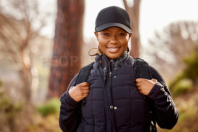 Buy stock photo Outdoor, portrait and black woman hiking in nature for physical exercise, mental and emotional wellbeing. Hiker, adventure and trekking with female person with smile, backpack and hobby in morning