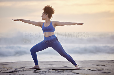 Buy stock photo Black woman, yoga and fitness for wellness at sea with peaceful mind, warrior pose and body. African person, zen and pilates workout at beach with stretching, spirituality and balance for mindset