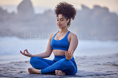 Buy stock photo Shot of a young female doing yoga on the beach