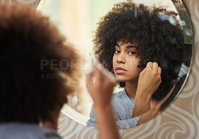 Buy stock photo Portrait of a beautiful woman looking in the mirror while applying makeup at home