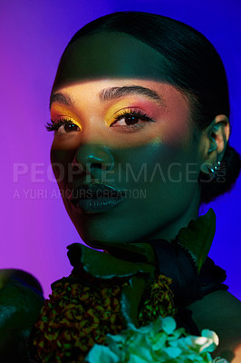 Buy stock photo Studio portrait of an attractive young woman posing with a bouquet against a colourful background