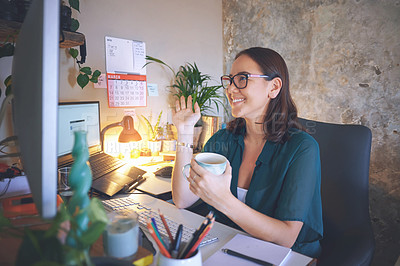 Buy stock photo Shot of an attractive young woman sitting alone and using her computer for a video chat while working from home