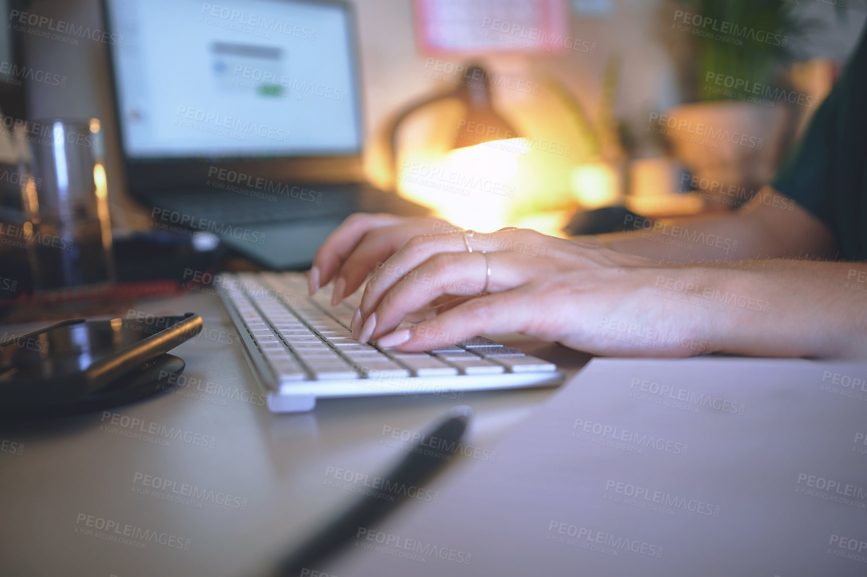 Buy stock photo Cropped shot of an unrecognizable woman sitting alone and using her computer to work from home