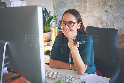 Buy stock photo Shot of an attractive young woman sitting alone and using technology while working from home