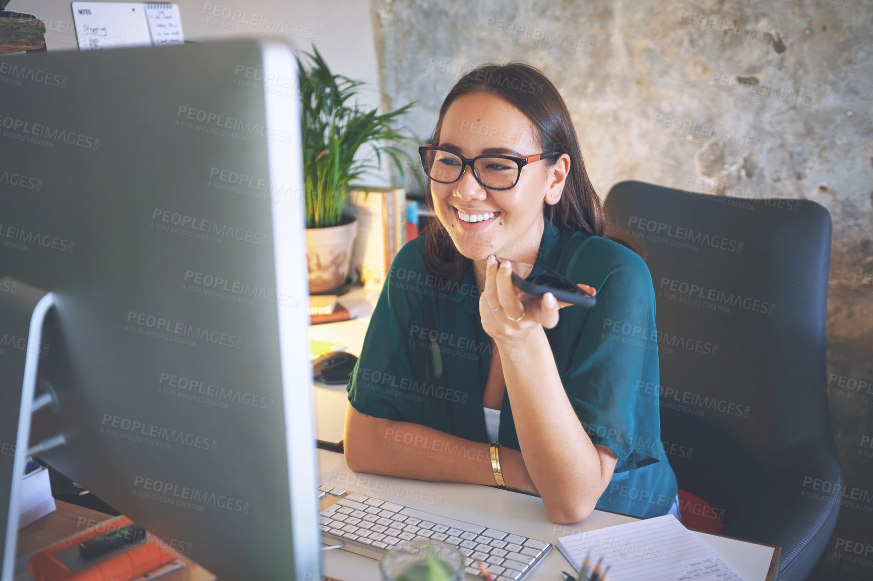 Buy stock photo Shot of an attractive young woman sitting alone and using technology while working from home