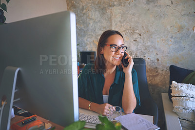 Buy stock photo Shot of an attractive young woman sitting alone and using her cellphone while working from home