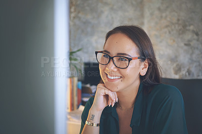 Buy stock photo Shot of an attractive young woman sitting alone and using her computer to work from home