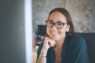 Buy stock photo Shot of an attractive young woman sitting alone and using her computer to work from home