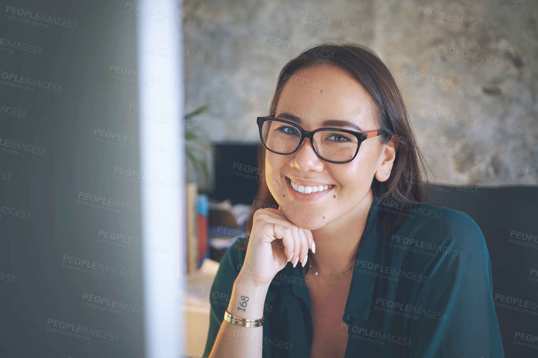 Buy stock photo Shot of an attractive young woman sitting alone and using her computer to work from home