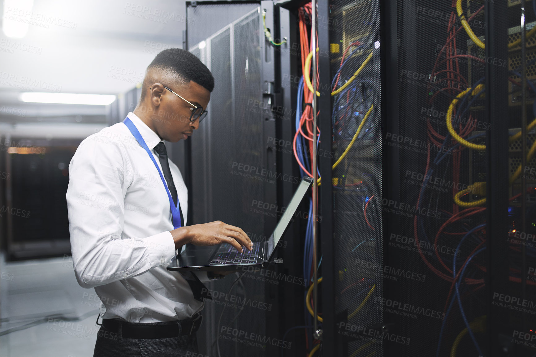 Buy stock photo Black man, engineer and server room with laptop for network repair, hardware or storage at data center. Male person, IT technician and computer for technical issue, internet service or system backup