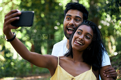 Buy stock photo Shot of a young couple taking a selfie while out on a date