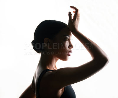 Buy stock photo Silhouette shot of a beautiful young woman posing against a white background