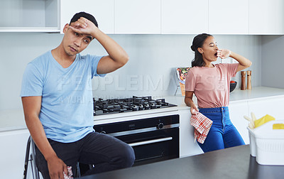 Buy stock photo Shot of a young couple taking a break from cleaning their kitchen