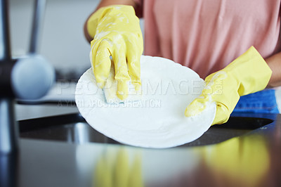 Buy stock photo Shot of a woman washing dishes in her kitchen