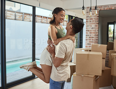 Buy stock photo Shot of an affectionate couple celebrating in their new home