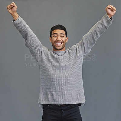 Buy stock photo Celebration, happy and portrait of a man in a studio cheering for success, winning or achievement. Happiness, excited and male model winner with fist pump to celebrate a victory by a gray background.