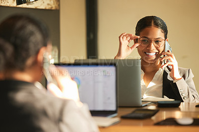 Buy stock photo Shot of a young businesswoman using a laptop while looking in the mirror at work