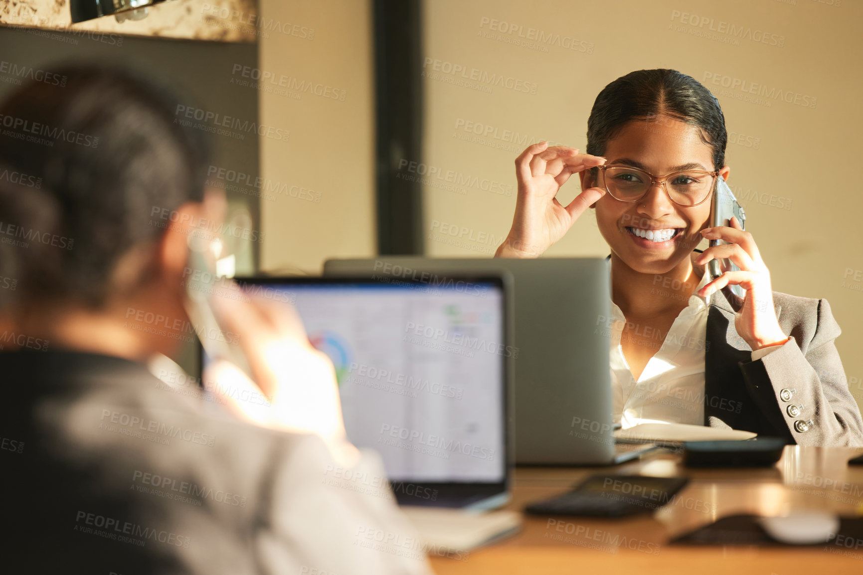 Buy stock photo Shot of a young businesswoman using a laptop while looking in the mirror at work