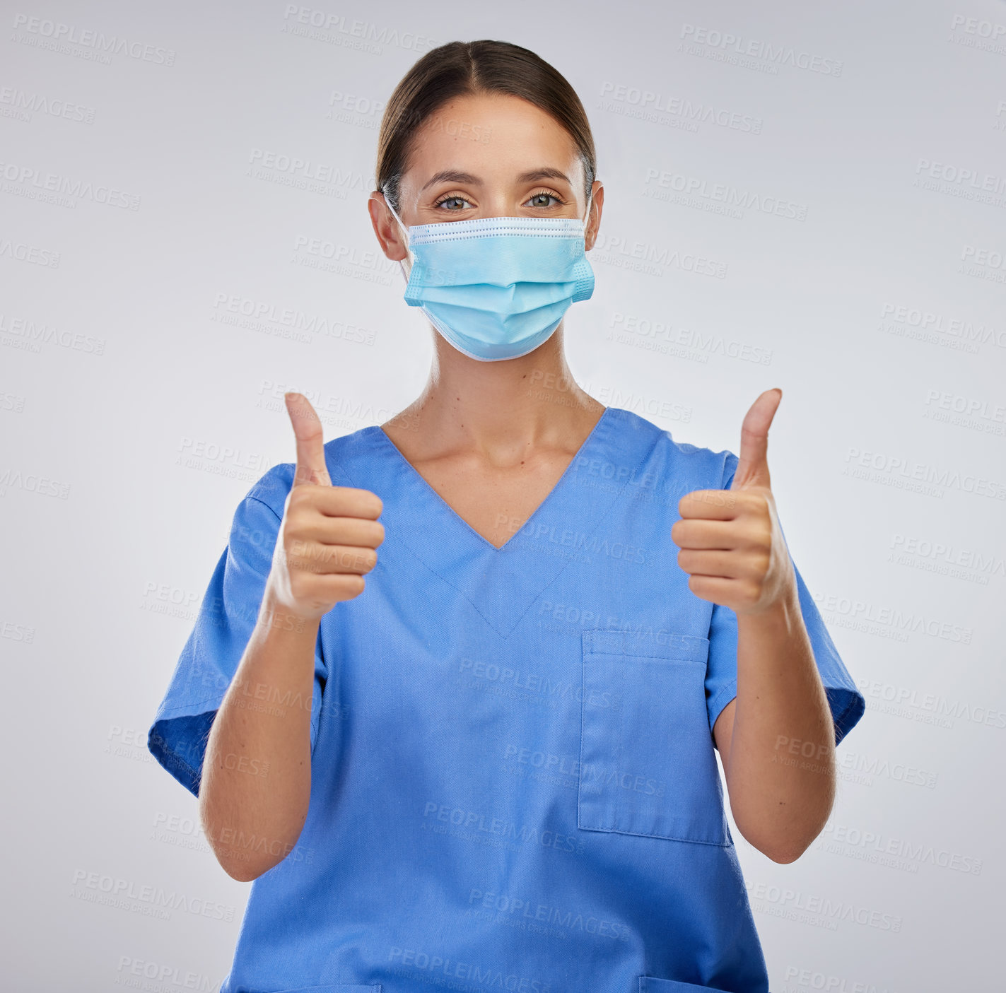 Buy stock photo Studio, nurse and woman with thumbs up, portrait and mask for safety, yes and thank you for healthcare. White background, medical and person in mockup, professional and healthy in clinic and expert