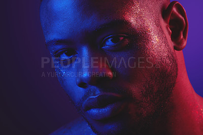 Buy stock photo Shot of a handsome young man standing alone and posing in the studio